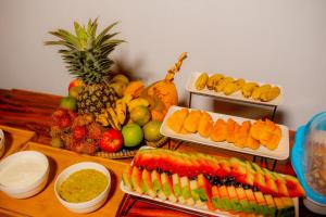 a table topped with lots of different types of fruits and vegetables at PALM CULTURAL VILLAGE in Paje