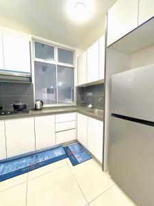 a kitchen with a refrigerator and a scale on the floor at SKS Habitat 461 2BR 4-5pax Larkin Johor Bahru in Johor Bahru