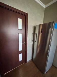 a door in a room with a metal refrigerator at Комнаты в собственном доме in Vanadzor