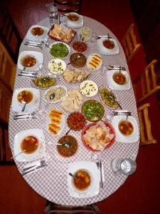 a table topped with plates and bowls of food at Guesthouse Angelina in Ushguli