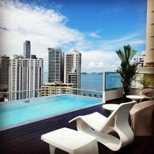 a balcony with a swimming pool on a building at Impressive City View Apartment Marbella - PH Quartier Marbella in Panama City