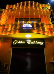 a sign for a coliden restaurant on a building at Paradise Golden Residency in Kottakupam