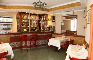 a restaurant with two tables and a bar at Atlantik Hotel in Vyborg