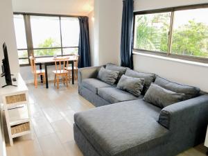 a living room with two couches and a table at 90 Eden Sands 2 Bedroom Flat with Beach Access in Kingsburgh