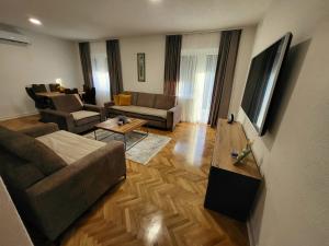 a living room with a couch and a table at Apartments & Spa - Insula Vita in Bihać