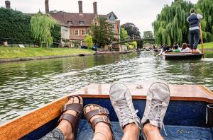 a person with their feet on a boat on a river at Twenty Four in Hythe