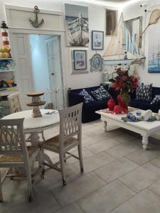 a living room with a table and a couch at La Battigia B&B in Trabia