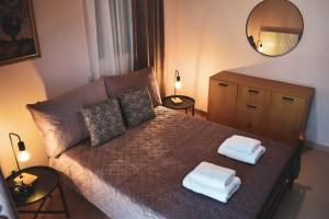 een slaapkamer met een bed met twee handdoeken erop bij Rose Garden Villa 