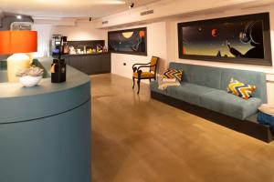 a living room with a couch and a table at Maria Luisa by INTROVERT HOTELS in Sofia