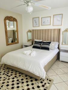 a bedroom with a large bed with towels on it at Avis sunrise view in Windhoek