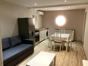 een woonkamer met een bank en een tafel en een keuken bij Appartement in Montélimar