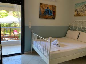 a baby crib in a room with a balcony at Γαλήνη in Salamina