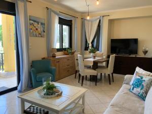 a living room with a couch and a dining room at Γαλήνη in Salamina