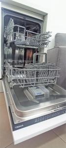 a dishwasher with its door open in a kitchen at SeawaveSunGranCanaria in Telde