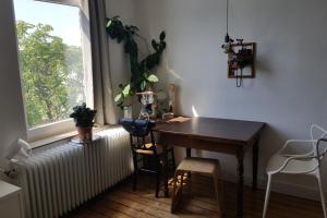 a room with a desk and a window with a radiator at Private Apartment in Hannover