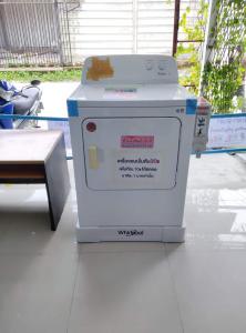 a washing machine sitting on top of a floor at Pa Chalermchai Guesthouse in Bangkok