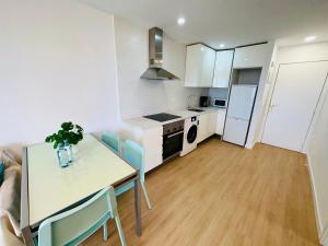 a kitchen and dining room with a table and chairs at Torres del Sol Playa de Las Vistas FREE WIFI in Playa de las Americas