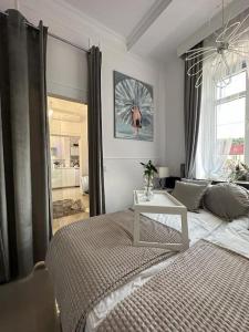 a bedroom with a bed and a window at Salt INN Apartments No 2 - jacuzzi in Wieliczka