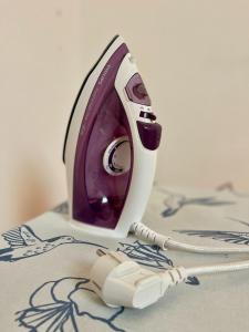 a purple and white phone sitting on a table at Prijeten prostoren apartma v hiši in Pivka