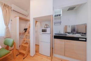 a small kitchen with a sink and a microwave at Nakano Five in Tokyo