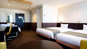 ein Hotelzimmer mit 2 Betten und einem Tisch in der Unterkunft le Lac HOTEL Otsu Ishiyama in Ōtsu