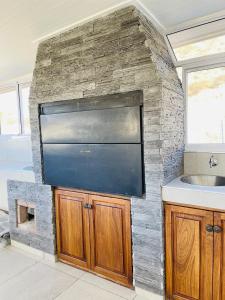 a kitchen with a stone wall and a sink at Avis sunrise view in Windhoek