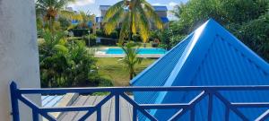 a blue fence next to a swimming pool at Furnished Townhouse - Grand Baie in Grand Baie