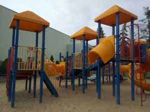 a playground with a bunch of playground equipment at Apartament Słoneczny in Poznań