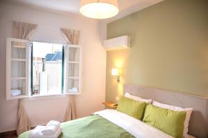 a bedroom with a bed and a window at Twin House Spetses in Spetses