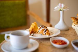 a table with a plate of pastries and a cup of coffee at Movenpick Taba Resort & Spa in Taba