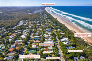 an aerial view of a beach with houses and condos at Tallow Beach Motel in Byron Bay