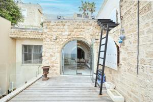 a ladder leaning against the wall of a building at Outstanding Old Jaffa Villa facing the Sea by HolyGuest in Tel Aviv