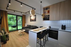 a kitchen and living room with a table and chairs at Krakowskie Malediwy by JoApart - Tauron Arena, Expo in Krakow