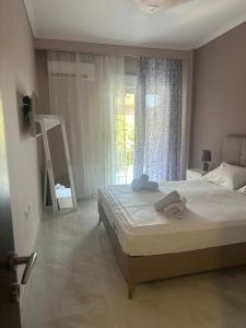 a bedroom with a large bed and a window at Greek Escape in Paleo Tsifliki