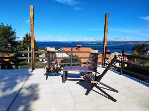 a deck with a bench and a view of the water at Bellavista Resort in Koper