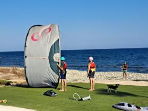 a group of people standing next to a large kite on the beach at House Near The Beach (Militsa & Aggeliki) in Pervolia