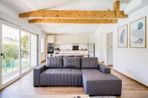 a living room with a couch and a kitchen at Villa Constance - Antibes in Antibes