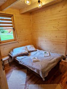 a bedroom with a bed in a wooden cabin at Domki i pokoje Daglezja pod Górą Żar in Międzybrodzie Żywieckie