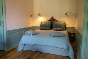 a bedroom with a bed with two pillows on it at La chambre de Manon in Hesdin