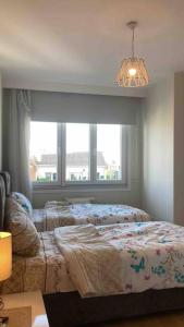 a bedroom with a bed in front of a window at 2+1. شقة فاخرة في بشاك شهير in Basaksehir