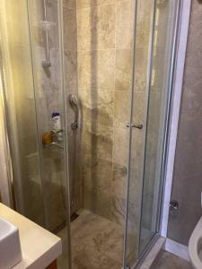 a shower with a glass door in a bathroom at 2+1. شقة فاخرة في بشاك شهير in Basaksehir