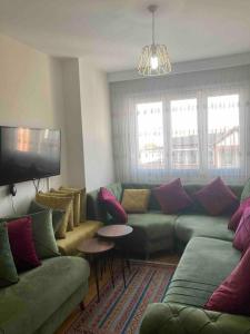 a living room with a couch and a tv at 2+1. شقة فاخرة في بشاك شهير in Basaksehir