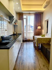 a kitchen with a table and a dining room at Апартаменты Ясная Поляна in Odesa