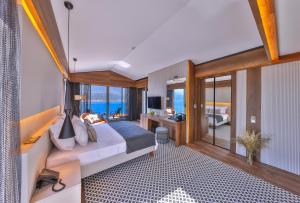 a bedroom with a bed and a desk in a room at Casa Bi Otel in Kas