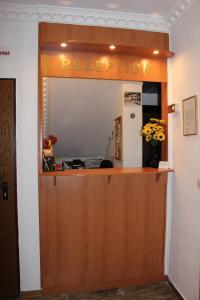 a reception room with a door and a refrigerator at Hotel zu den Burgen in Kamp-Bornhofen