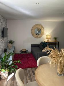 a living room with a couch and a mirror at A louer appartement t2 in Espalion
