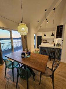een keuken en eetkamer met een houten tafel en stoelen bij Villa LUX Apartments in Rogoznica