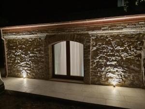 a stone wall with a window and lights on it at OH QUANT’E’ BELLA L’ACQUABELLA in Ortona