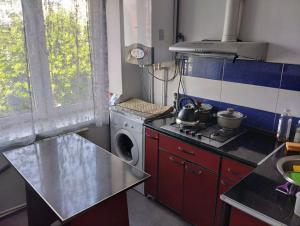 a kitchen with a stove and a washing machine at Однокомнатная квартира от городской суеты in Gyumri