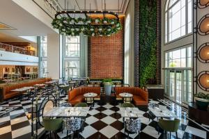 a restaurant with a checkered floor and tables and chairs at The Westin Dubai Mina Seyahi Beach Resort and Waterpark in Dubai